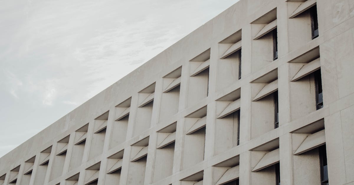 Low-angle view of a modern concrete building facade in Austin, TX.