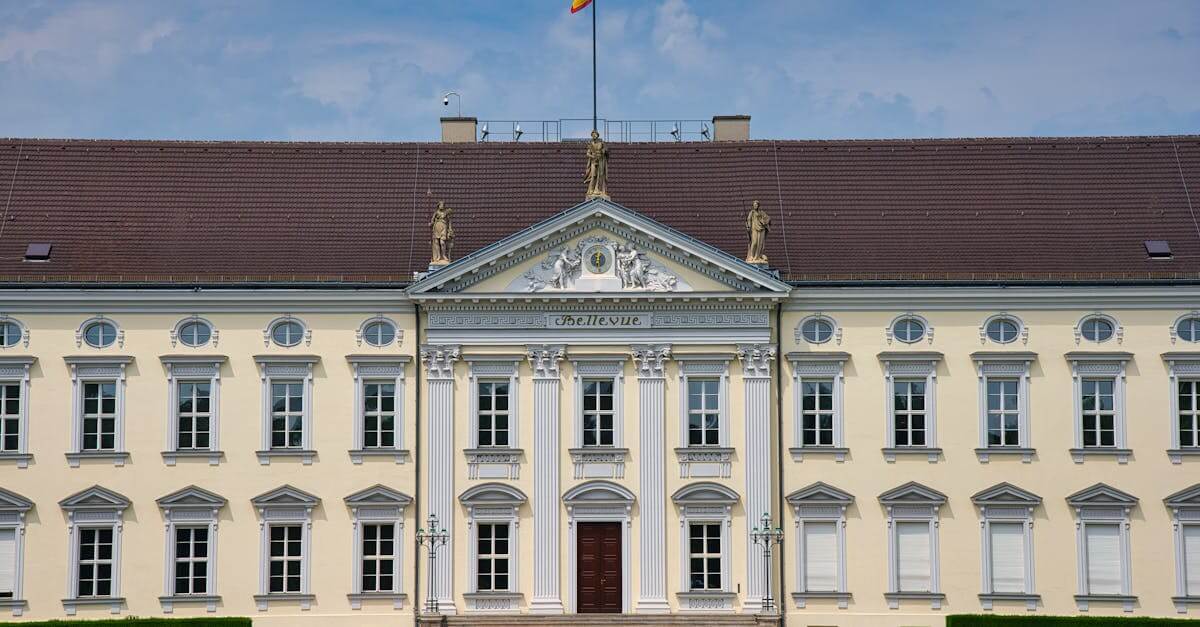 Bellevue Palace in Berlin, Germany, with blue sky and green lawns.