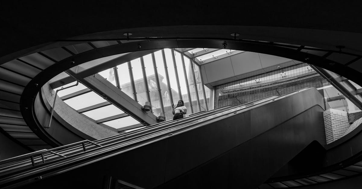 Black and white photo of modern architecture and escalator at Berkeley BART station.