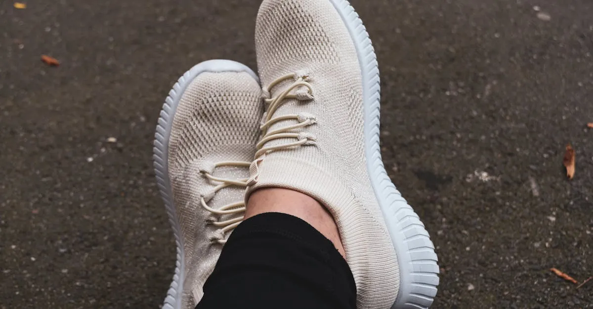 Fashionable cream sneakers on pavement, showcasing casual urban style.