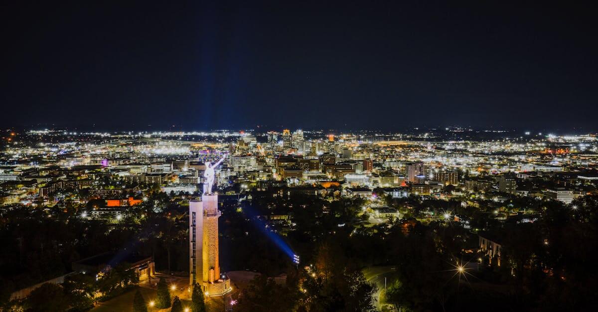 Aerial view of Birmingham's nighttime skyline featuring the iconic Vulcan statue.