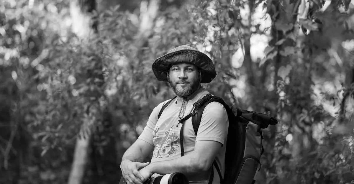 Black and white portrait of a photographer with camera in Shady Hills forest.