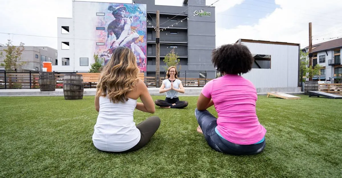 Three women practicing yoga outdoors in Denver, embracing mindfulness and healthy living.