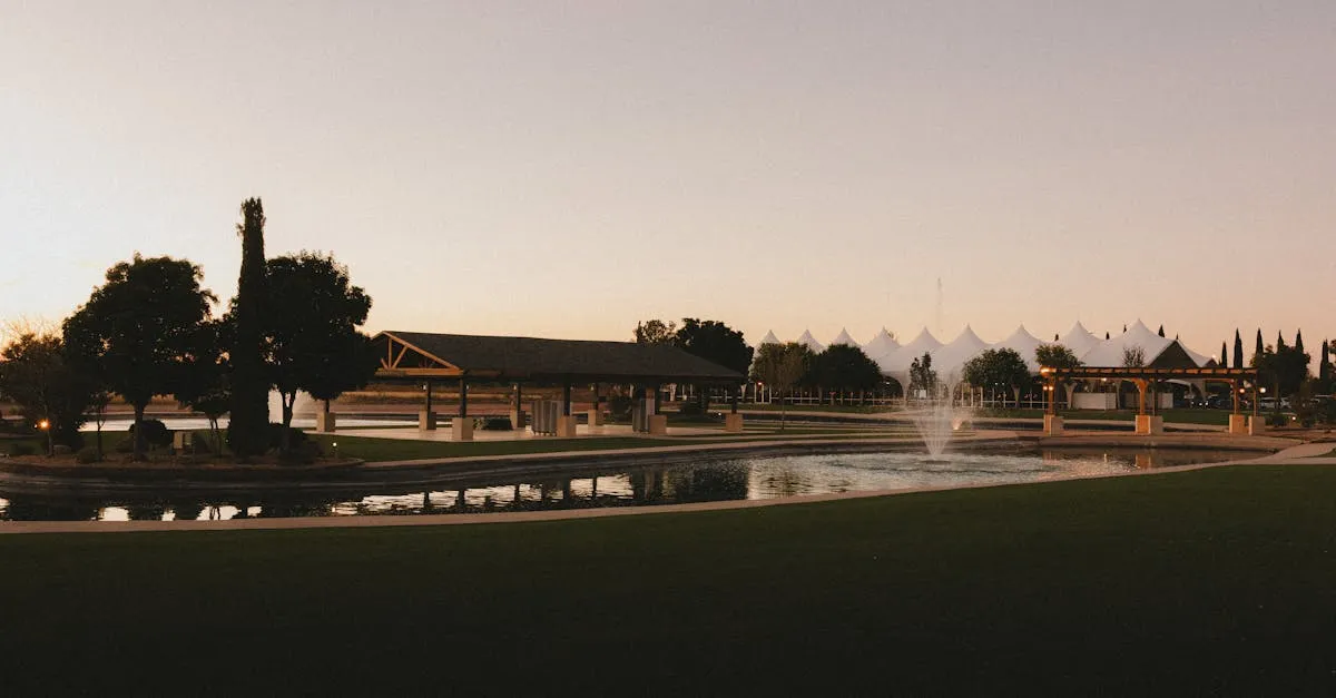 Tranquil park setting in El Paso, Texas at sunset with fountains and trees.
