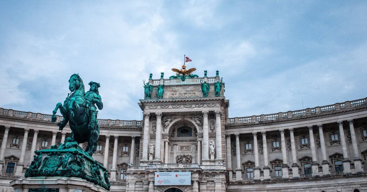 Majestic equestrian statue and Hofburg Palace in Vienna, showcasing classic architecture and cultural heritage.