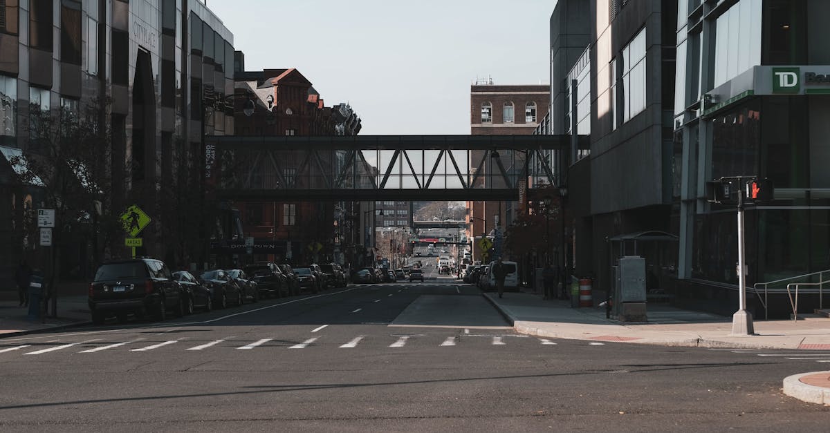 Street view of downtown Hartford, CT featuring modern and historic architecture with an overhead walkway.