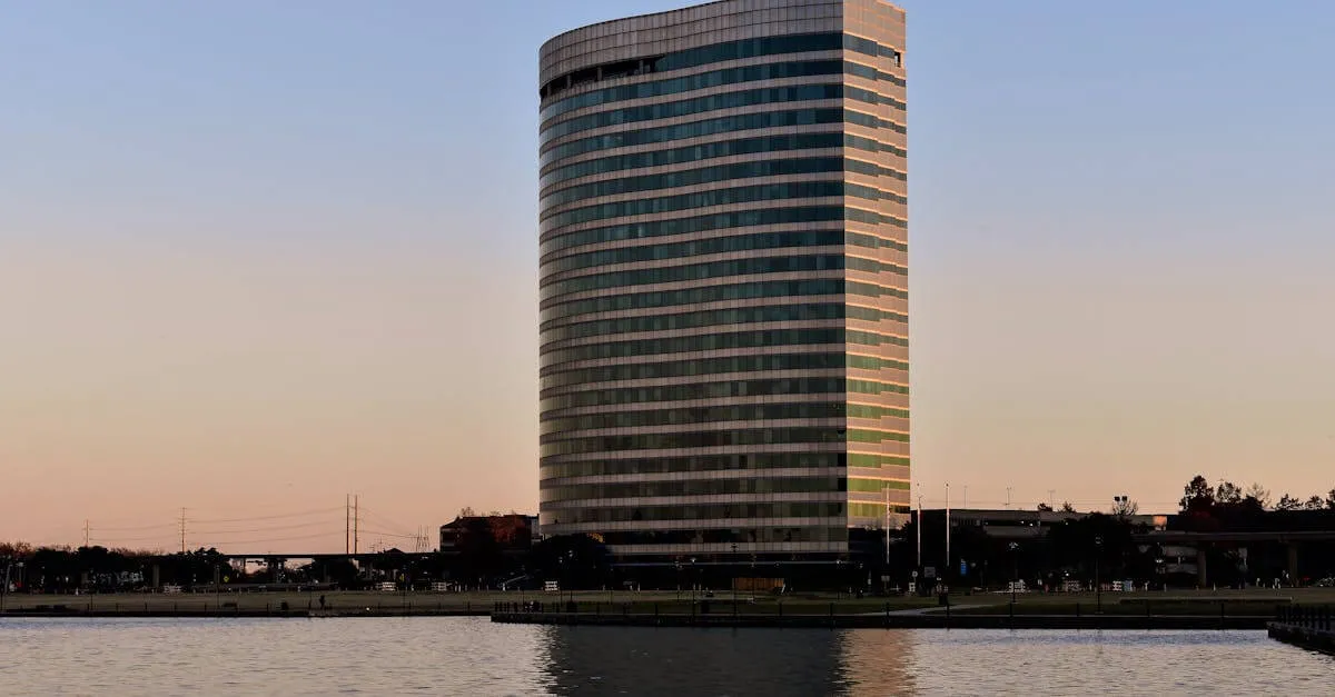 A sleek office building reflected on a lake at sunset in Irving, Texas, USA.