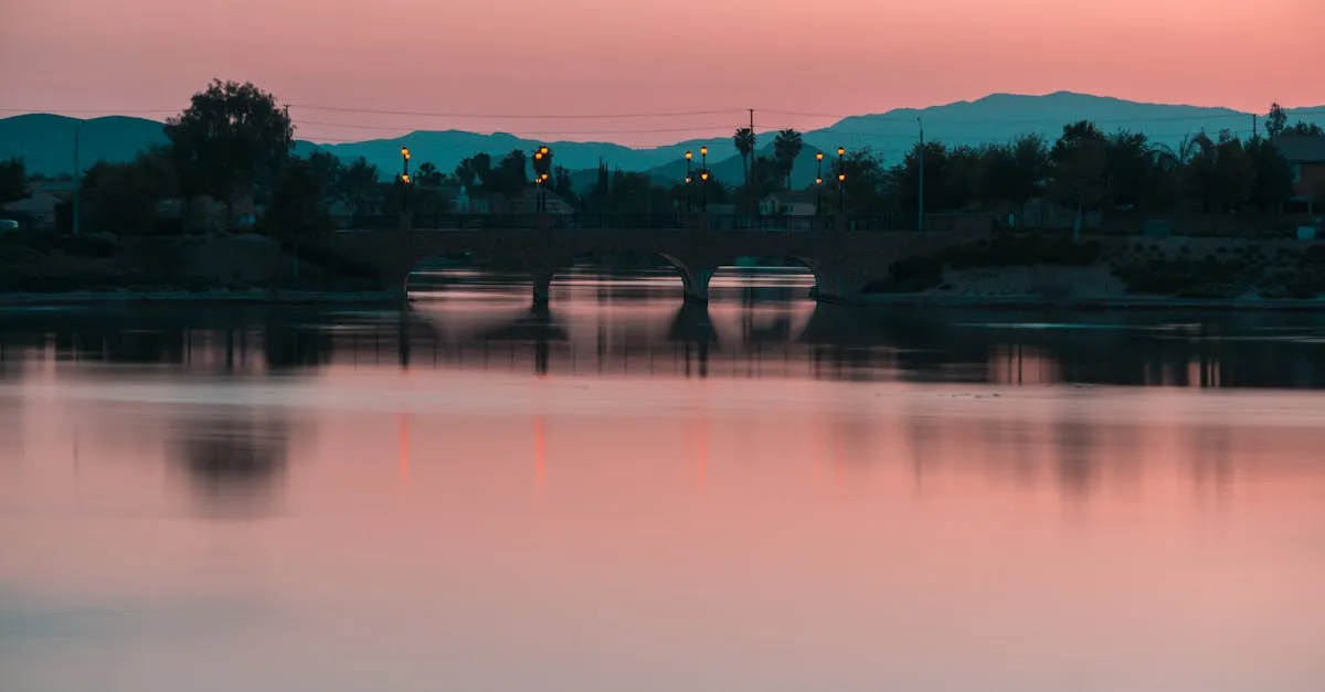 Peaceful Menifee bridge reflecting in calm waters at sunset.