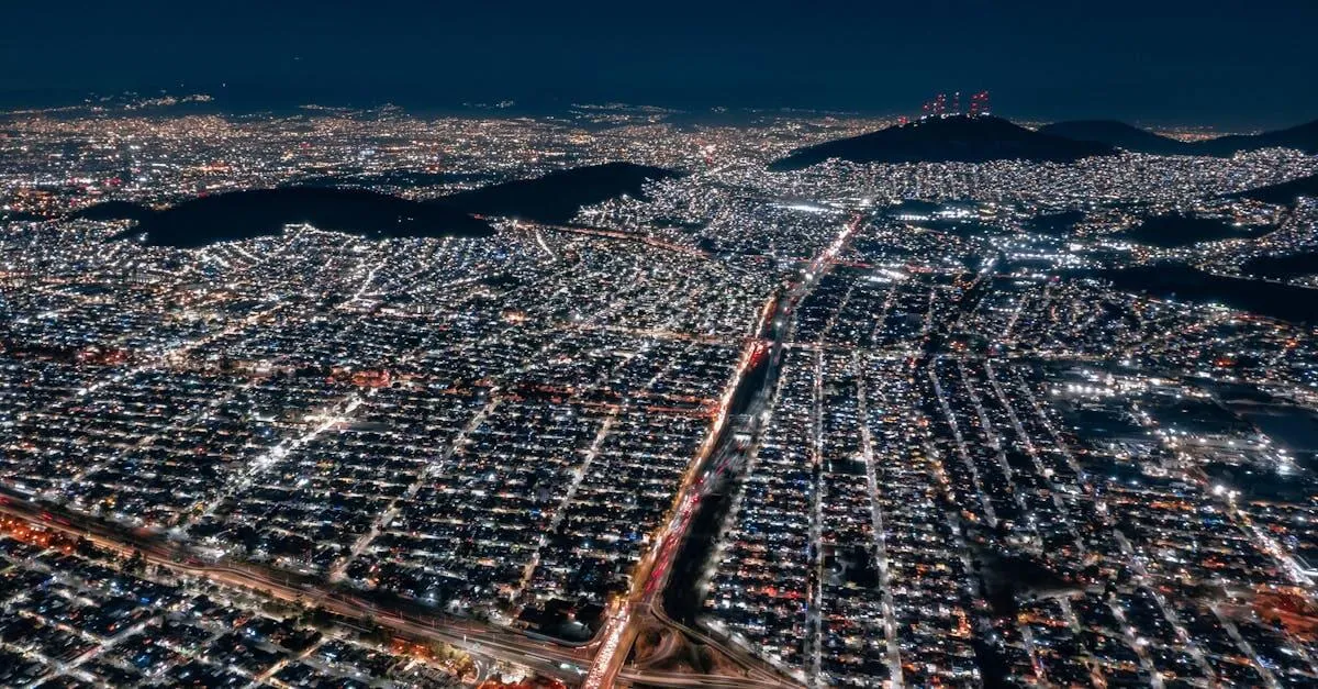 Stunning aerial view of illuminated Mexico City at night, showcasing urban sprawl and vibrant lights.