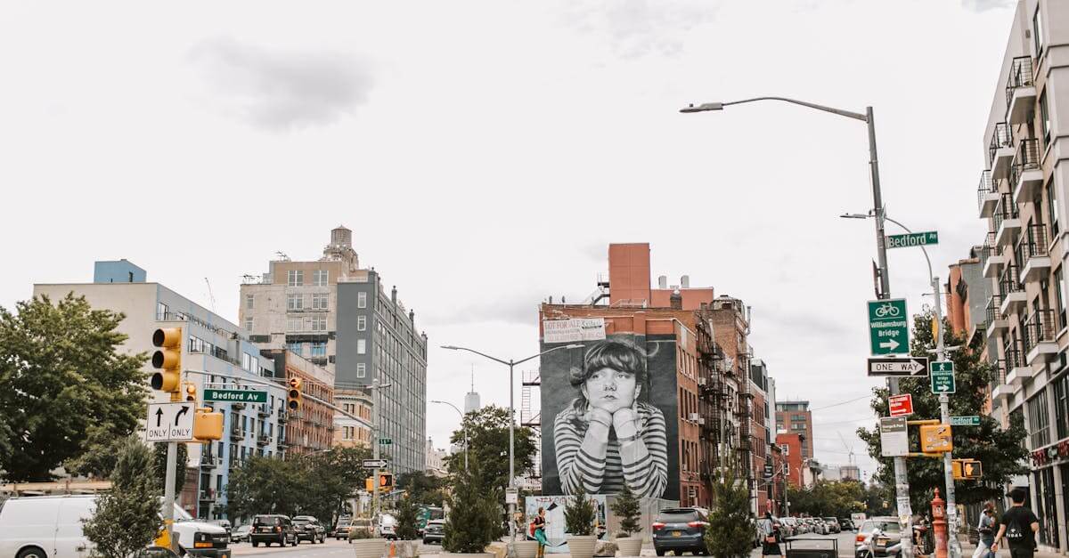 Vibrant street view of Bedford Avenue with famous mural and urban traffic in NYC.