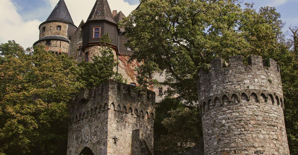 Explore the enchanting towers and historic architecture of Braunfels Castle amidst lush greenery.