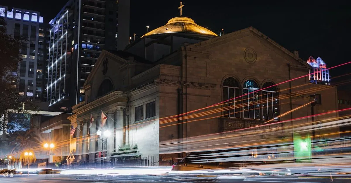A stunning night view of a church in downtown Orlando with vibrant light trails from passing cars, highlighting urban life.