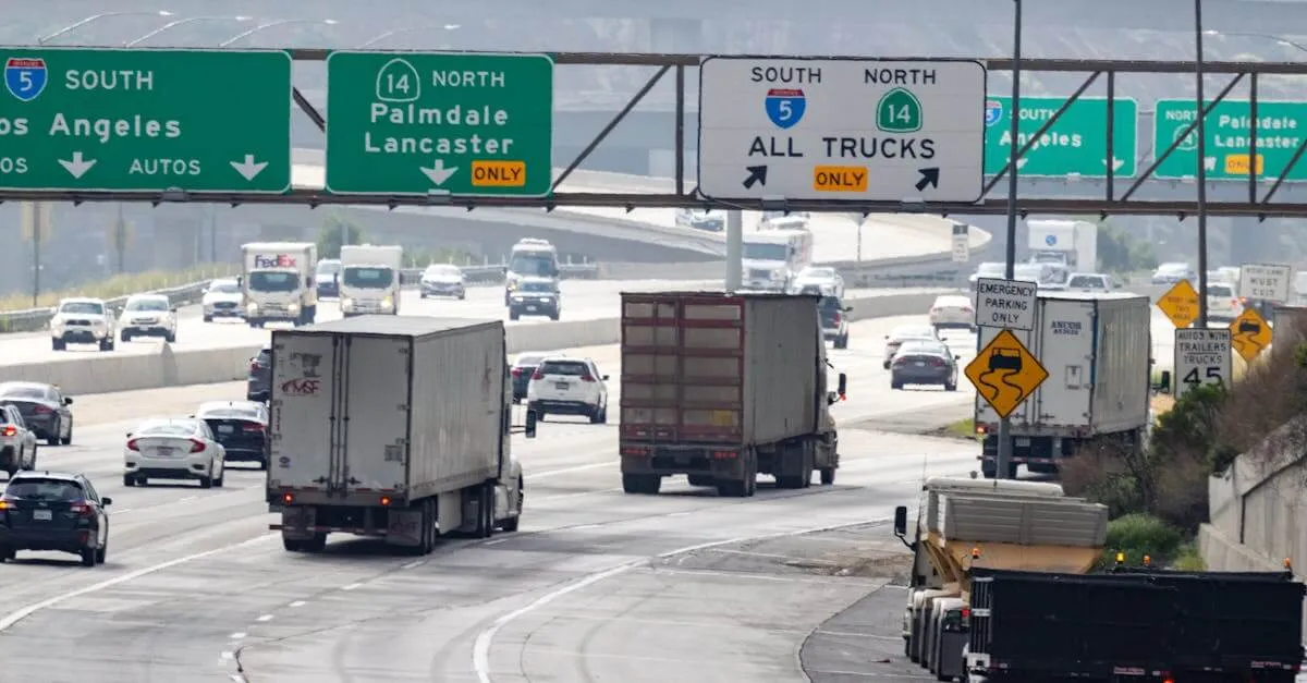 Traffic with trucks and cars on a highway in California heading to Los Angeles.