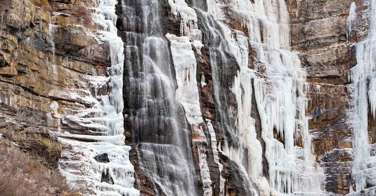 A breathtaking view of a frozen waterfall cascading down rocky cliffs in Provo Canyon, Utah.