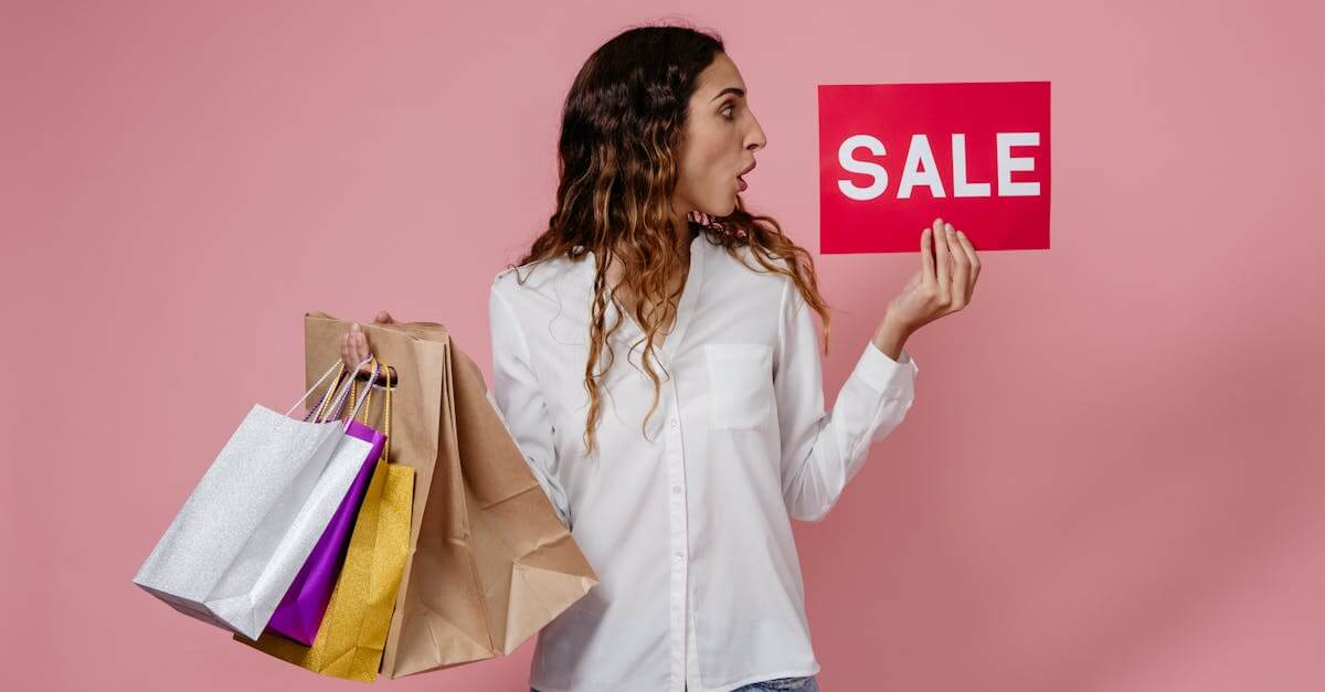 A surprised woman holding shopping bags and a sale sign against a pink background.