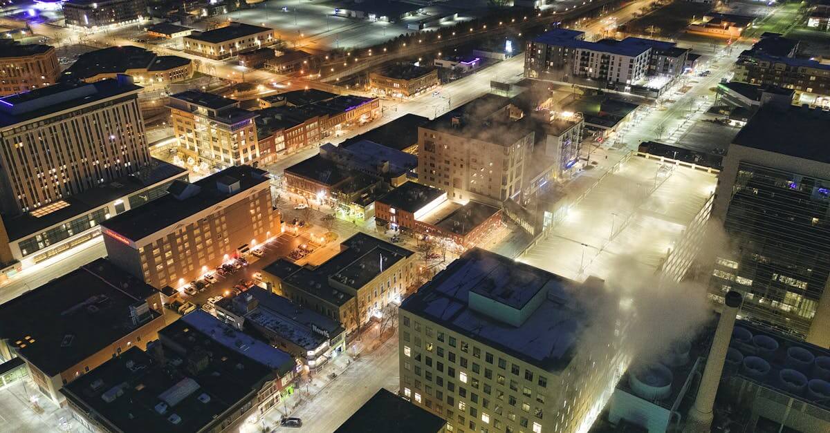 Stunning aerial view of downtown Rochester, MN, illuminated at night with city lights and streets in view.