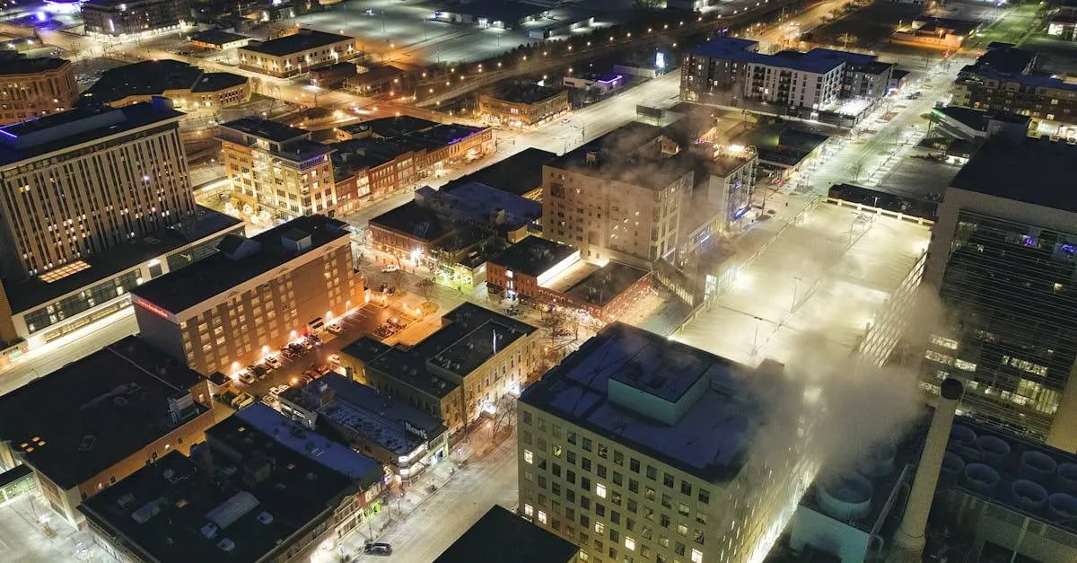 Stunning aerial view of downtown Rochester, MN, illuminated at night with city lights and streets in view.