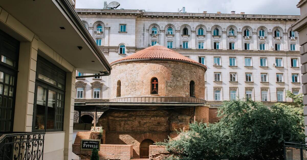 The ancient Rotunda of St. George in Sofia, Bulgaria, with modern backdrop.