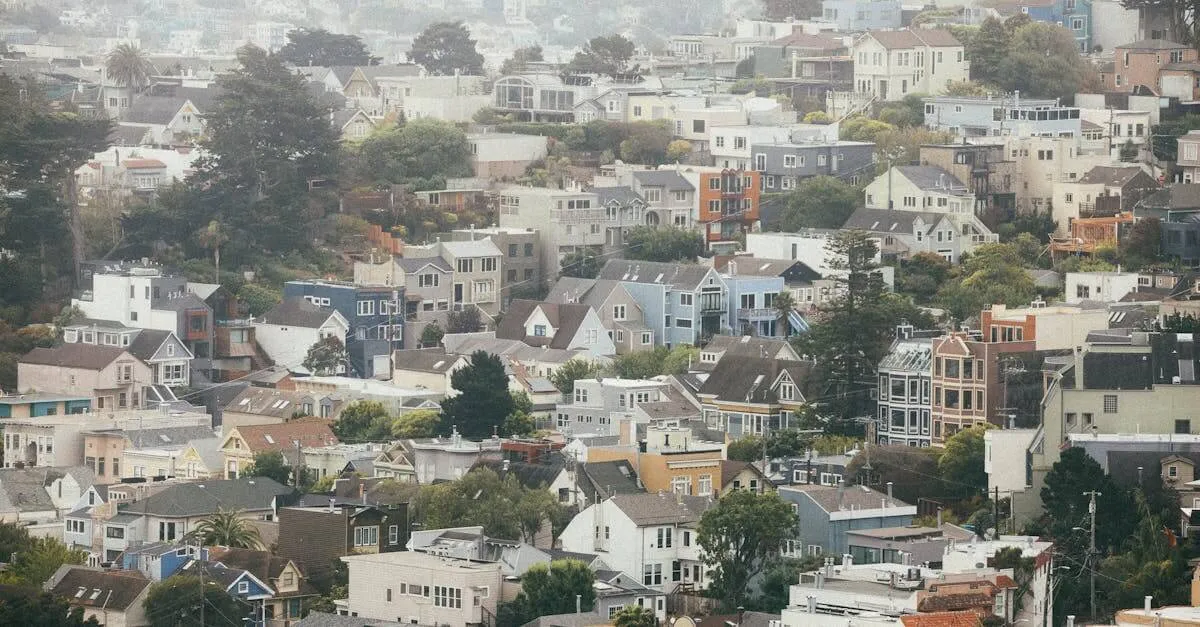 Scenic view of the foggy San Francisco hills with colorful houses under a cloudy sky.