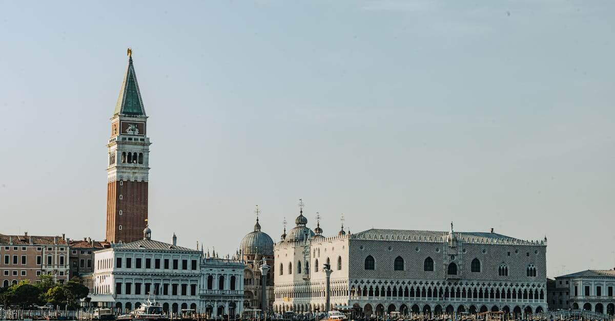 Discover Venice's iconic Doge's Palace and St. Mark's Campanile under a clear sky.
