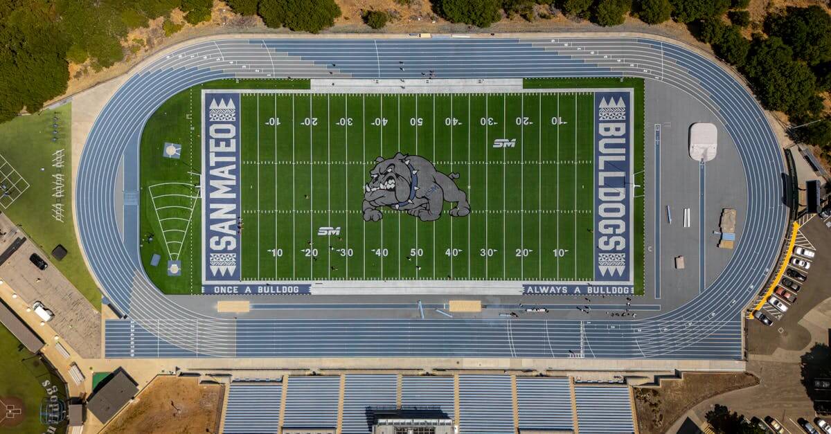 Aerial shot of San Mateo high school football field and track with bulldog logo and track lanes.