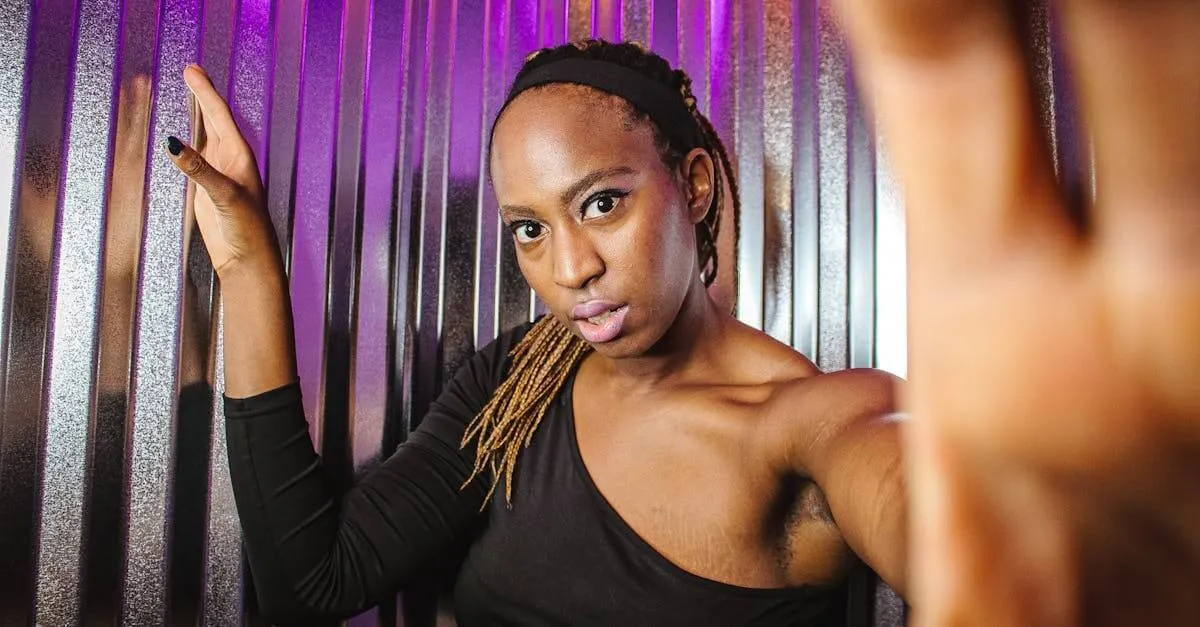 Fashionable black woman with dreadlocks posing against a metallic background in Scottsdale, AZ.
