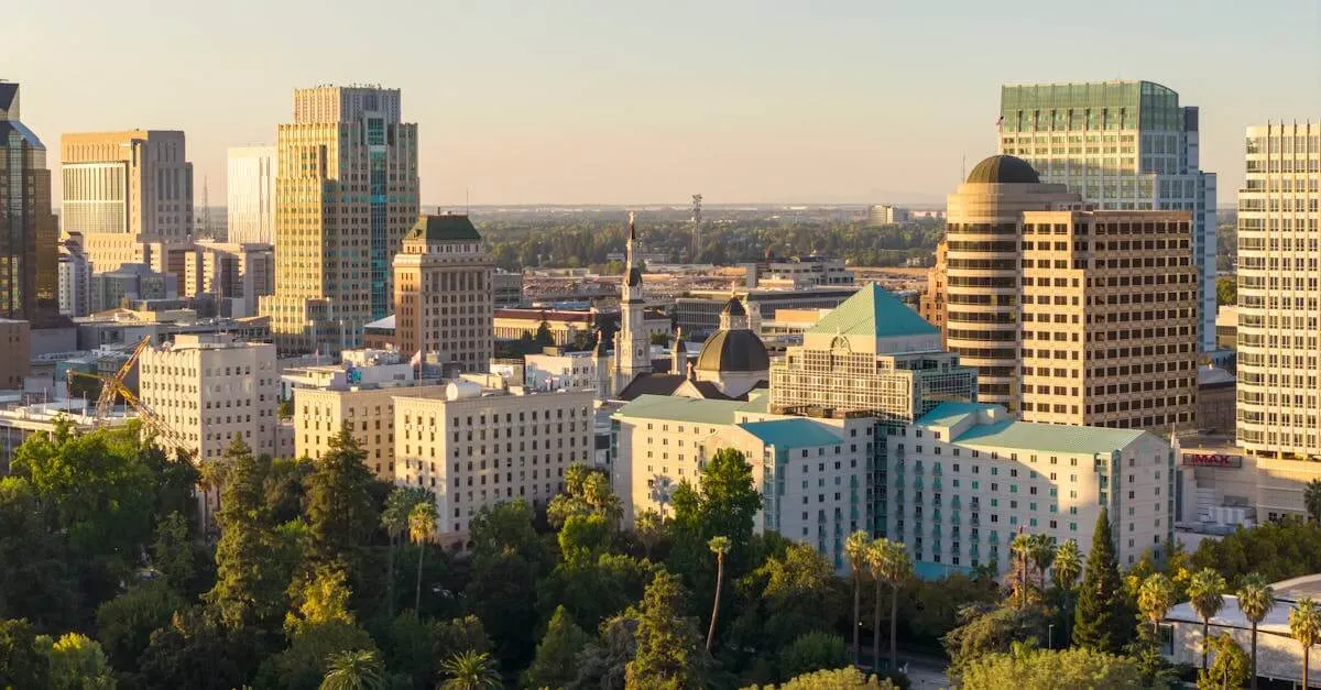 A stunning aerial view of downtown Sacramento skyline with lush greenery under the golden sunset light.
