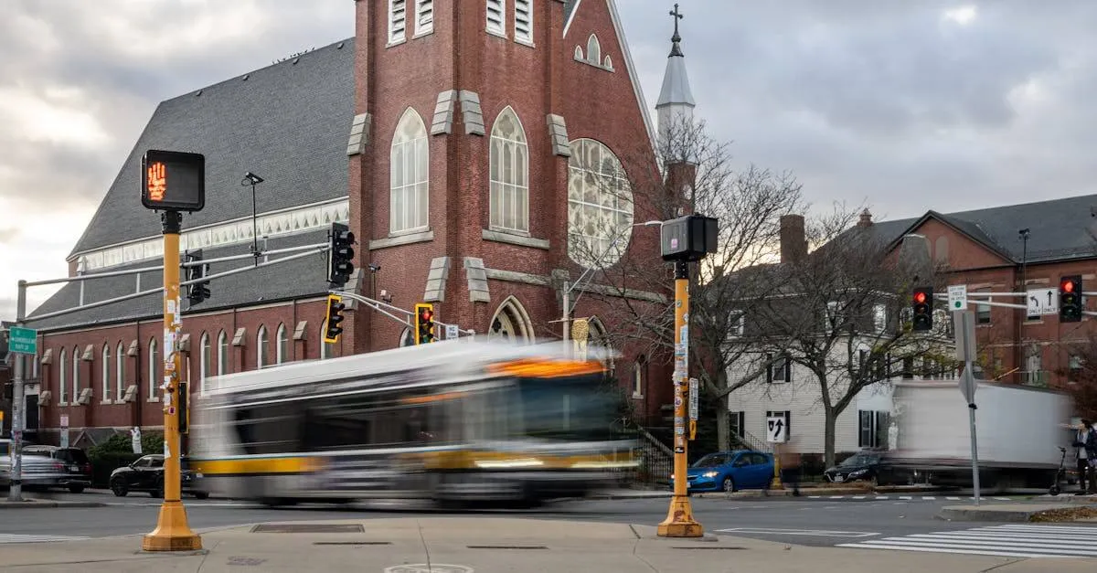 Brick church with moving bus at a busy Somerville intersection during the day.