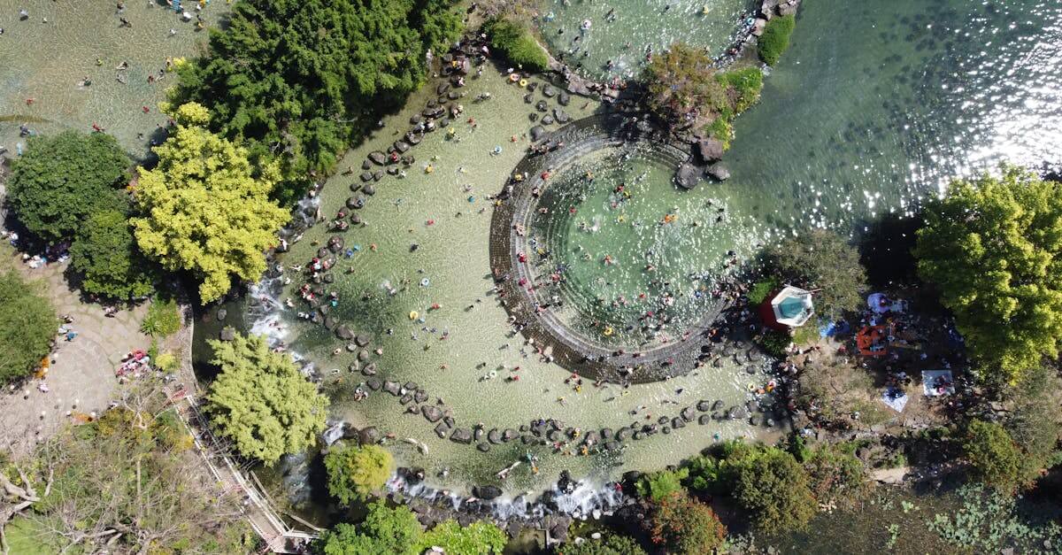 Aerial shot of Suoi Mo Park with people enjoying water activities in a lush setting.