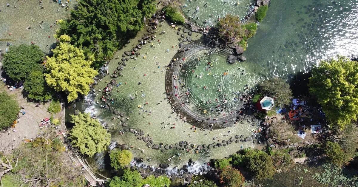 Aerial shot of Suoi Mo Park with people enjoying water activities in a lush setting.