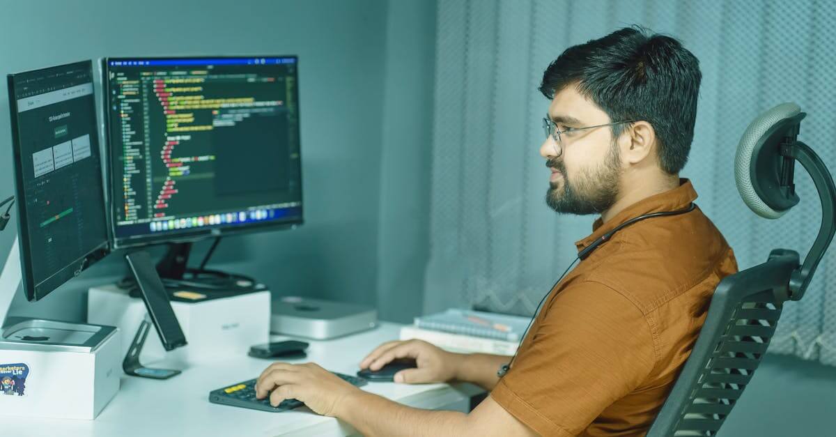 A focused developer coding at a modern office with dual monitors, showcasing a tech-driven workspace.