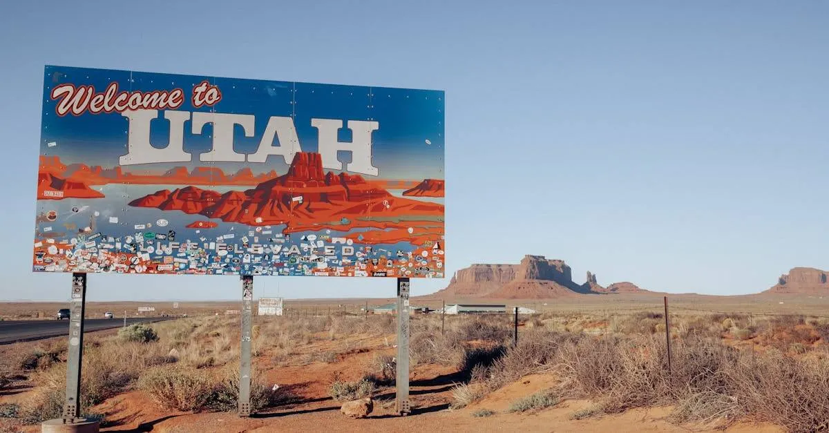 A 'Welcome to Utah' sign against a scenic desert backdrop with clear blue skies.