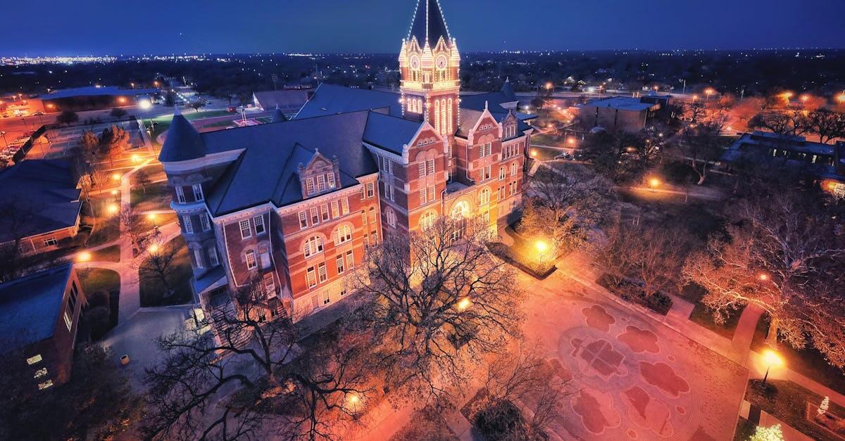 Stunning aerial night view of an illuminated university tower in Wichita, Kansas.
