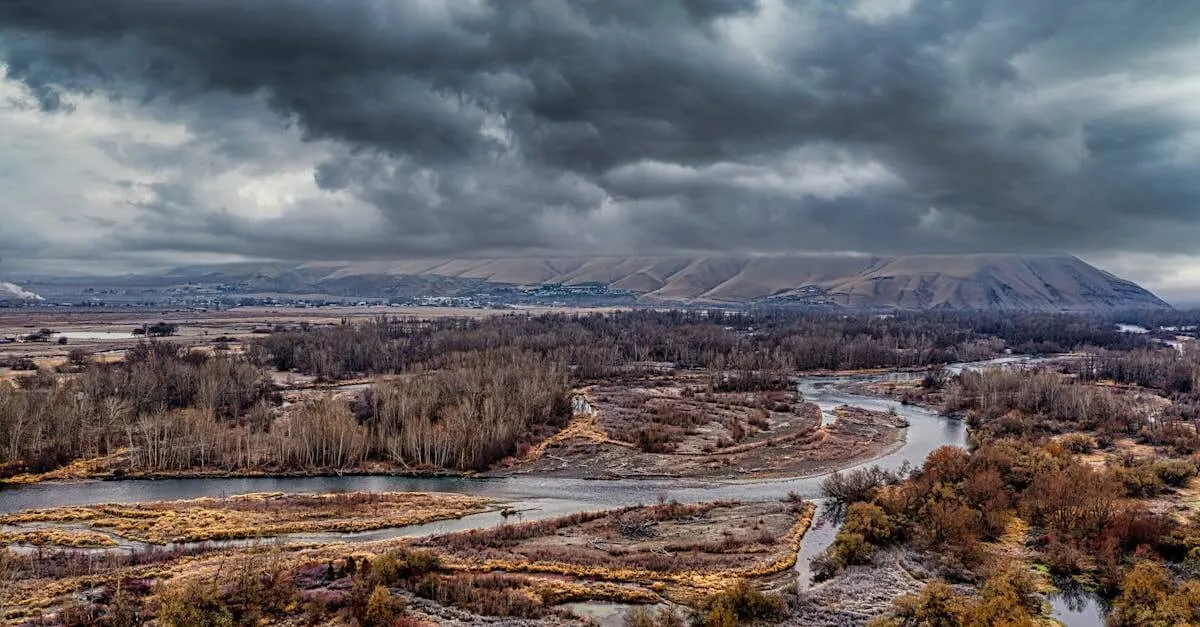 Aerial view of the Yakima River surrounded by rugged wilderness and dramatic clouds in fall.